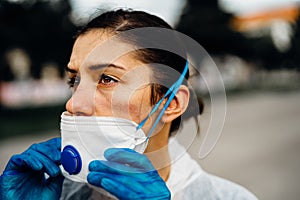Exhausted doctor/nurse wearing coronavirus protective gear N95 mask uniform.Coronavirus Covid-19 outbreak.Mental stress of photo