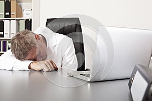 Exhausted doctor sleeping on his desk