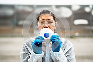 Exhausted emotional doctor/nurse wearing coronavirus protective gear N95 mask.Coronavirus Covid-19 pandemic outbreak.Frontline photo