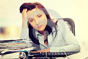 Exhausted female filling out tax forms