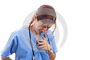 Exhausted female nurse grabbing painful heart area with hand