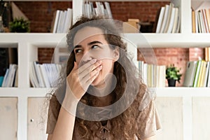 Tired teen student yawning feeling sleepy overwhelmed with studying