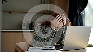 Exhausted female student or worker sit at home office desk looking away having sleep deprivation. Lazy millennial woman