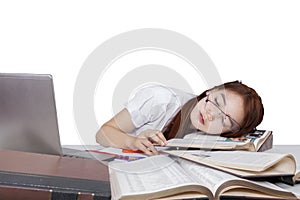 Exhausted girl sleeping on the book