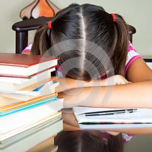 Exhausted girl sleeping on her desk