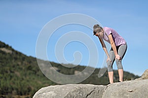 Exhausted jogger resting in the mountain