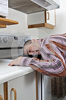 Exhausted man asleep in a frying pan