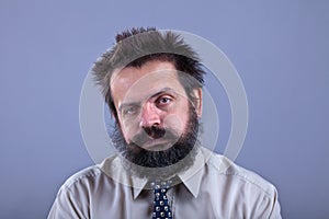 Exhausted man with bushy hair and beard