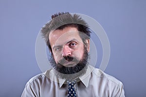 Exhausted man with bushy hair and beard photo