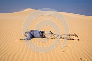 Exhausted man in the desert. Apathy, fatigue, exhaustion, mental disorders concept. Mental health