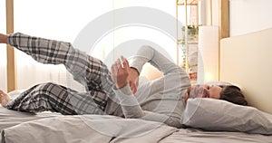 Exhausted man falling asleep on bed