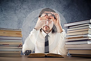 Exhausted man reading books