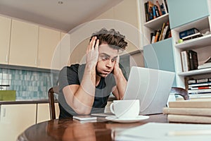 Exhausted man touching head while looking