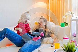 Exhausted mom fallen asleep on couch