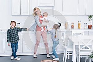 exhausted mother with three kids looking up