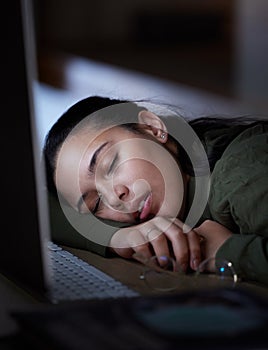 Exhausted, night and a business woman sleeping at her desk while working overtime in her office. Burnout, deadline and