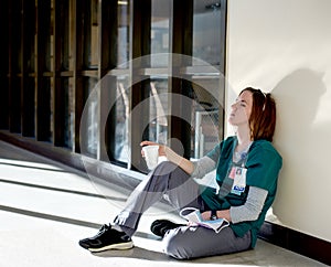 Exhausted nurse sitting on the floor