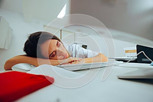 Tired Doctor Working Late on her Pc Computer Falling Asleep photo