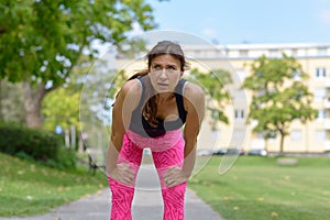 Exhausted runner leaning over with hands on knees