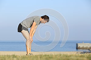 Exhausted runner man resting after workout