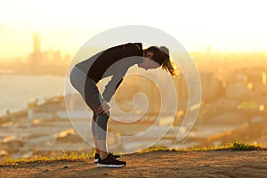 Exhausted runner resting after running in city outskirts