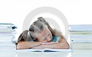 Exhausted schoolgirl falling asleep on her books after studying too much