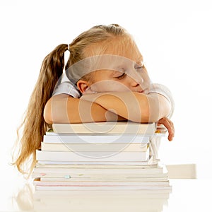Exhausted schoolgirl falling asleep on her books after studying too much
