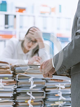 Exhausted secretary overloaded with work