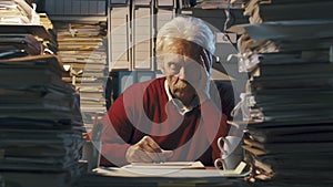 Exhausted senior office worker sleeping on the desk