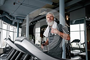 Exhausted senior man after working out in gym