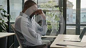 Exhausted sick mature senior businessman tired African American ethnic man office executive work on computer typing feel