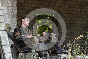 Exhausted soldier taking rest
