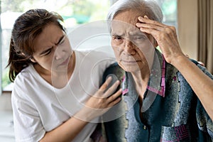 Exhausted tired asian senior woman touching head with her hands, ill elderly has vertigo,dizziness,sick old people suffering from