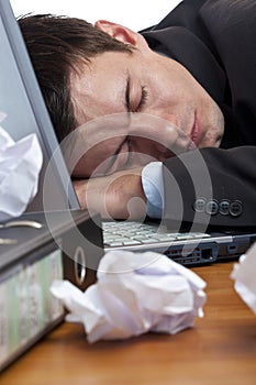 Exhausted, tired businessman sleeping at desk