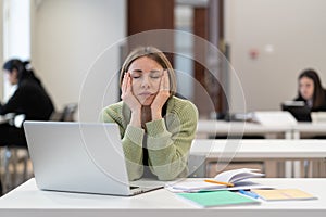 Exhausted tired middle-aged woman student falling asleep while studying at adult education class