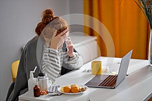 exhausted unhappy girl covered with plaid sitting on chair