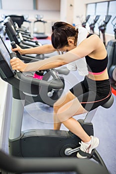 Exhausted woman on the exercise bike