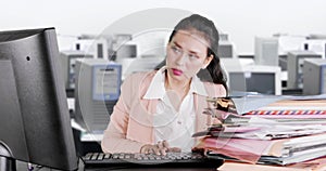 Exhausted woman looks sleepy in the office