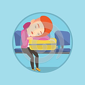 Exhausted woman sleeping on suitcase at airport.