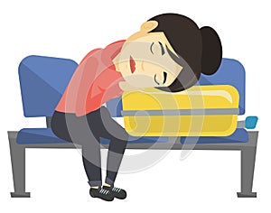 Exhausted woman sleeping on suitcase at airport.