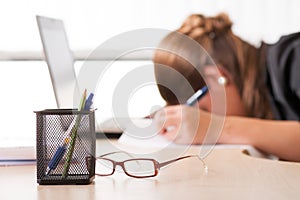 Exhausted woman sleeping at work