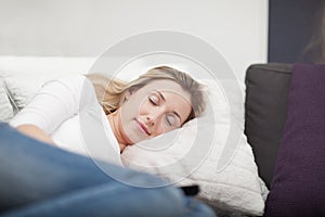 Exhausted woman taking a nap on the sofa