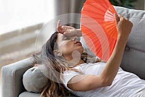 Exhausted woman use hand fan suffer from heat