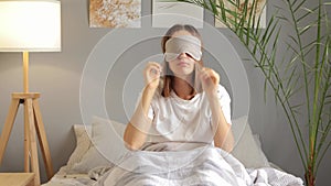 Exhausted woman wearing eye mask and lying to sleep needs more energy sleepless night tired looks felling fatigue depressed autumn