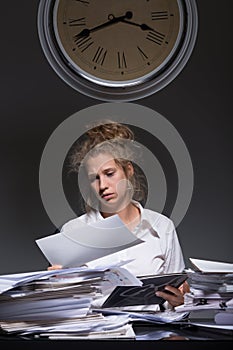 Exhausted worker doing paperwork