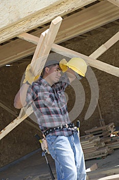 Exhausted Worker Holding Wooden Beams