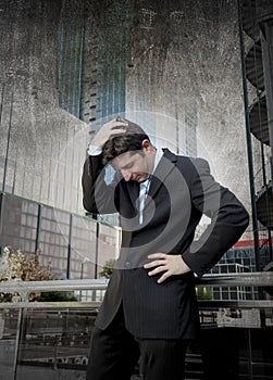 Exhausted worried businessman outdoors in stress and depression