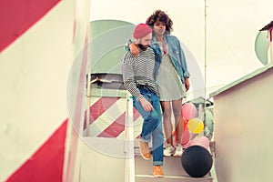 Exhausted young people walking downstairs after having long party