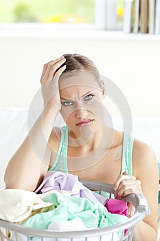 Exhausted young woman doing the laundry