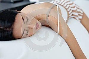 Exhausted young woman enjoying a refreshing sleep